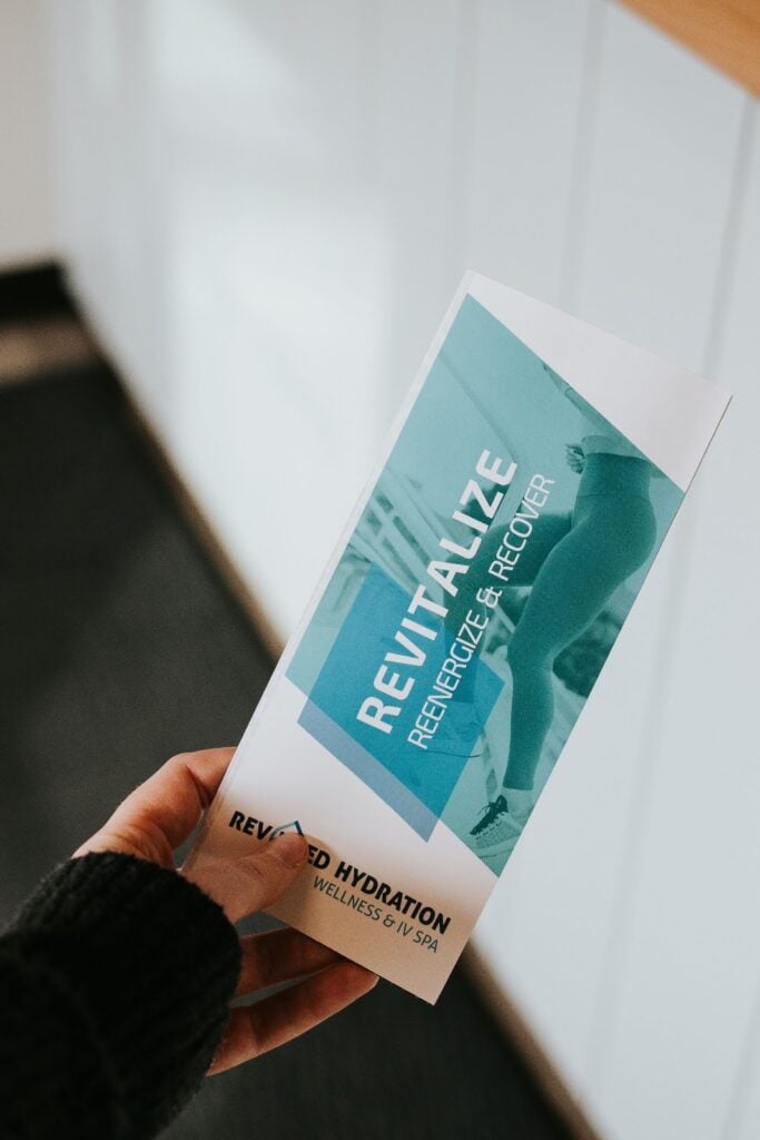 A person holding a design your company brochure