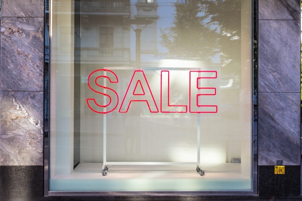 A display window with the word sale