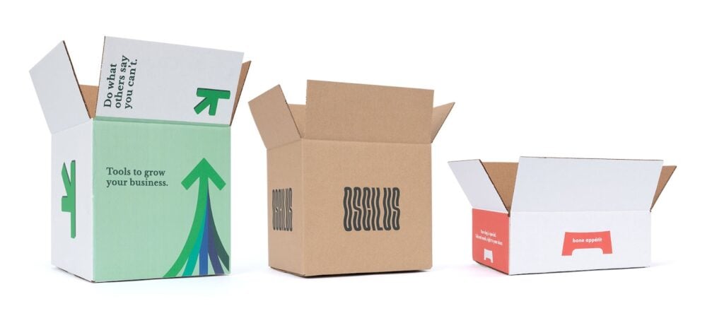 three shipping boxes. 2 white, 1 kraft