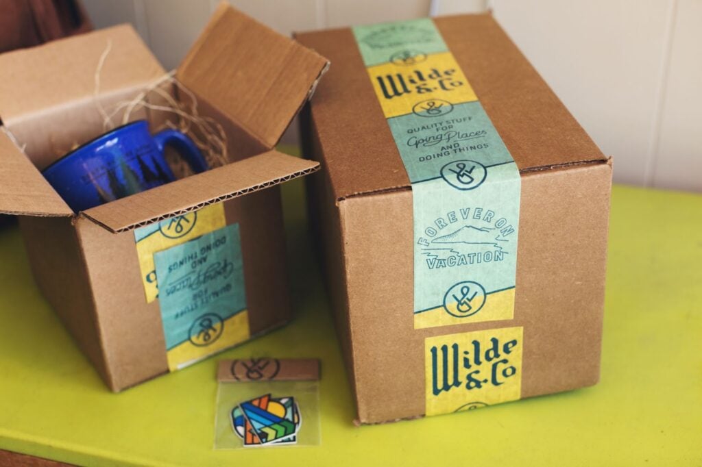 2 shipping boxes with custom branded printing tape