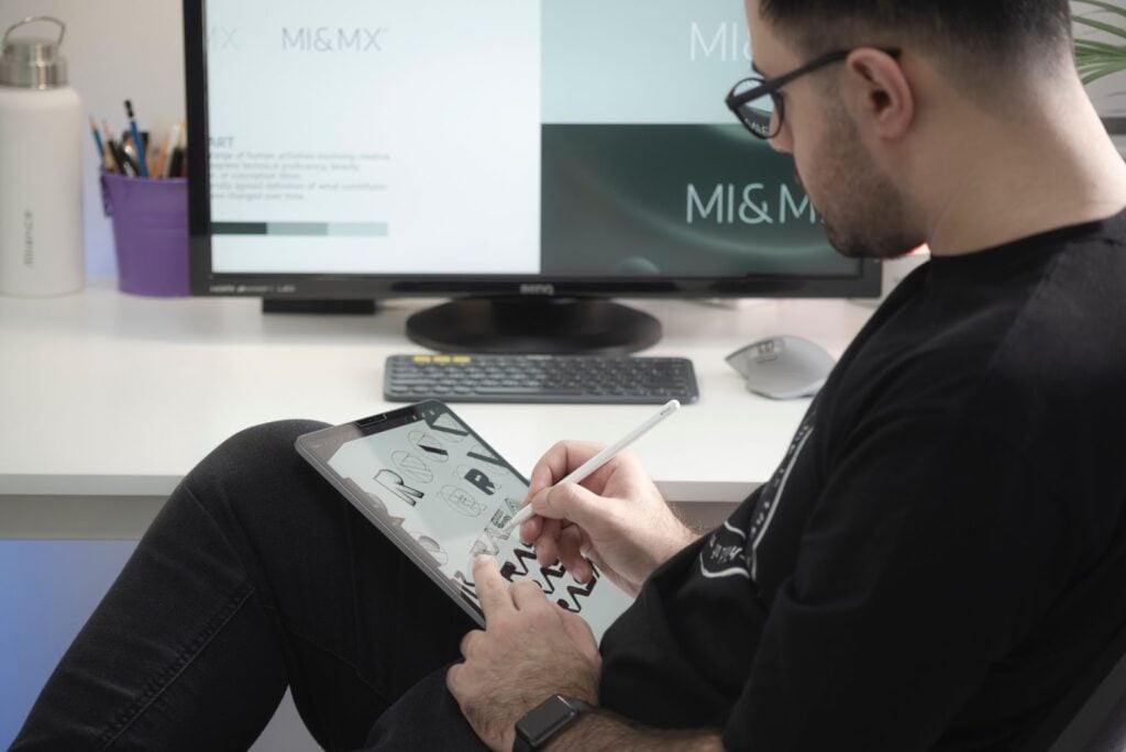Man graphic designing on computer and tablet