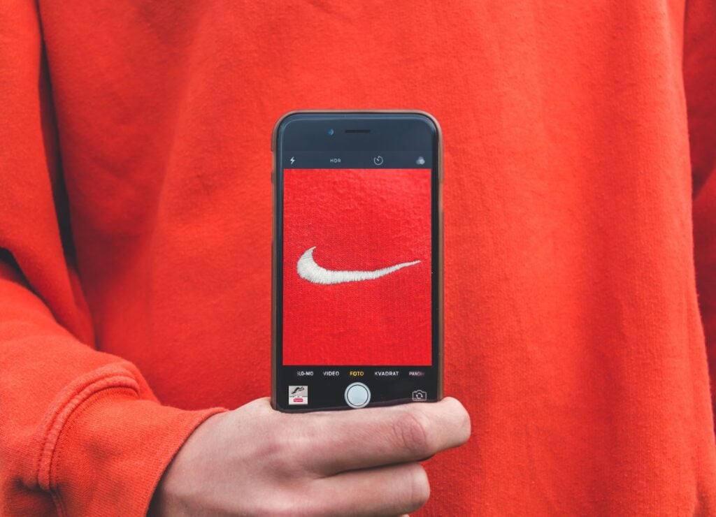 Nike swoosh logo in the center of a Iphone with the camera app open