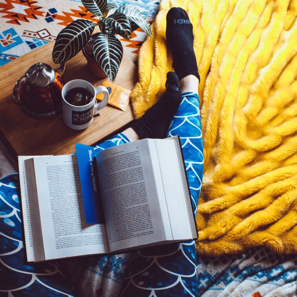 Bookmark in large book resting on a person's lap