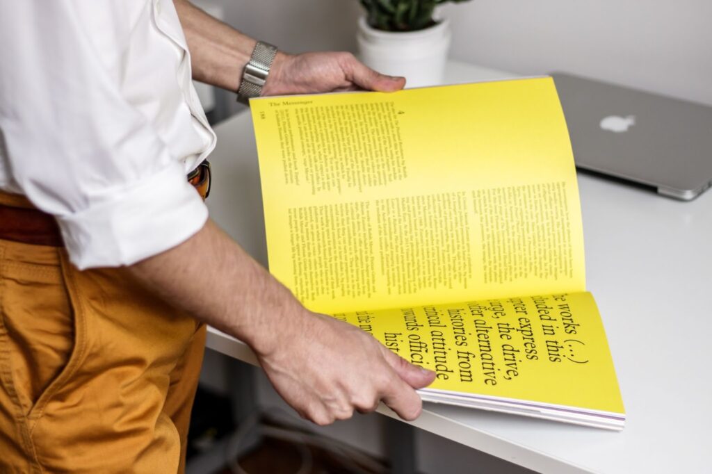 Person opening up a magazine