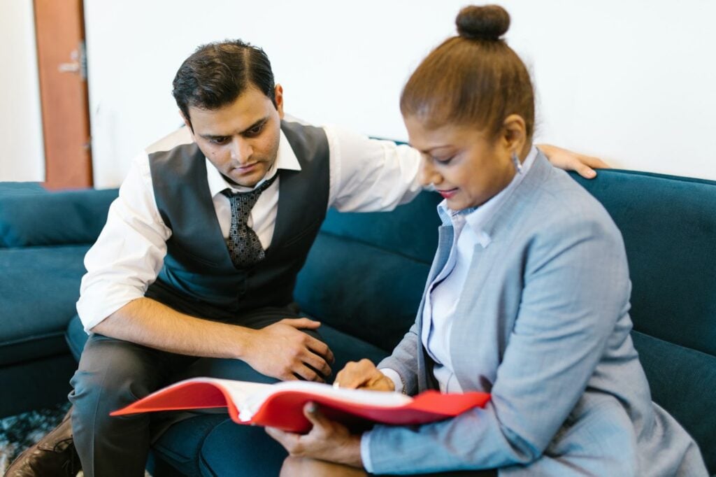 2 people looking through a presentation folder