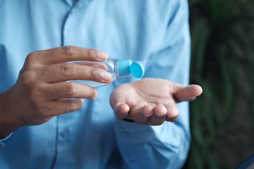 pouring hand sanitizer into hand