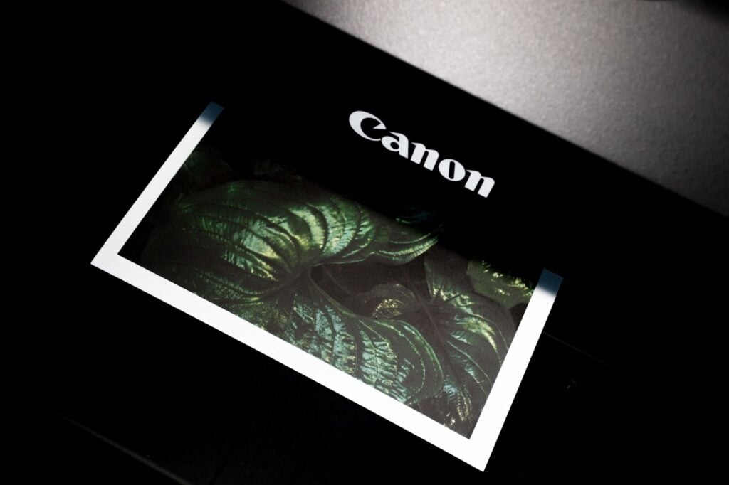 Printed paper with white border coming out of a printer 