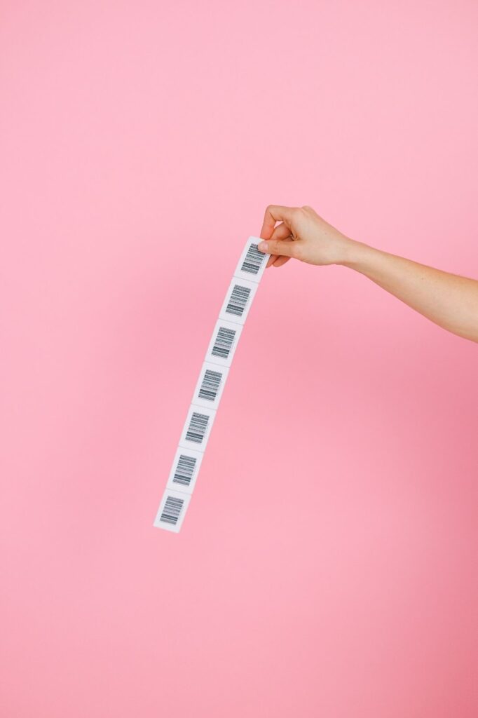 hand holding a strip of barcodes