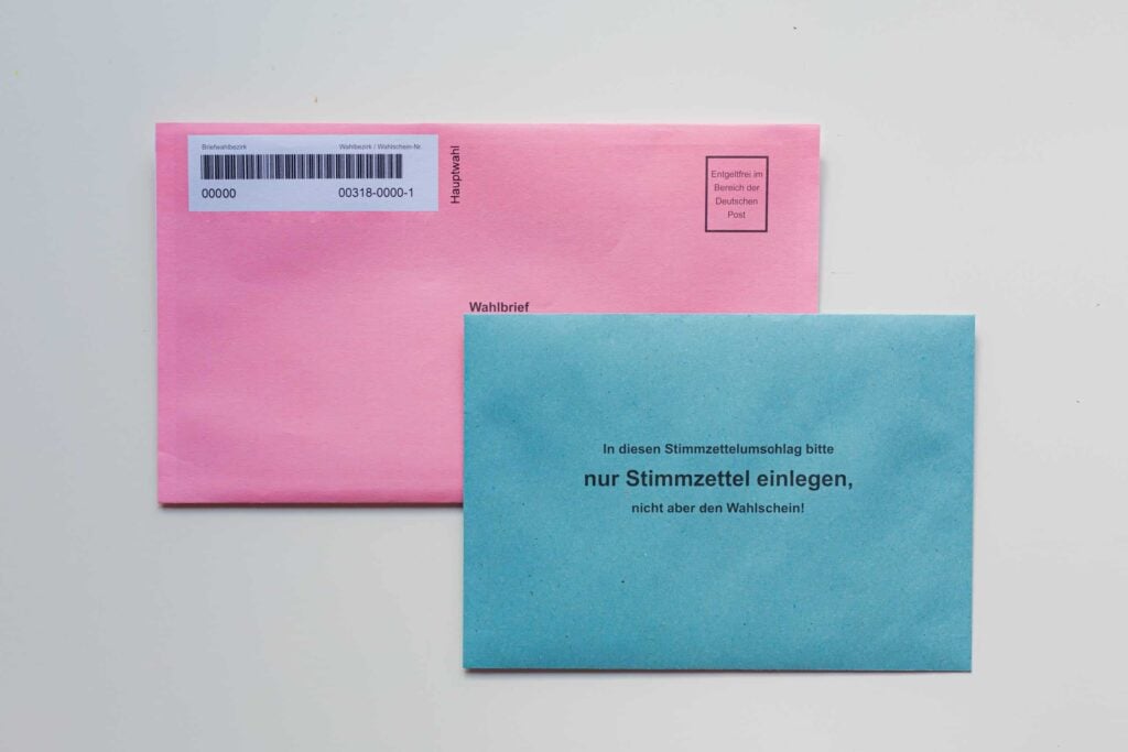 Pink and blue mailing envelopes with printed addresses