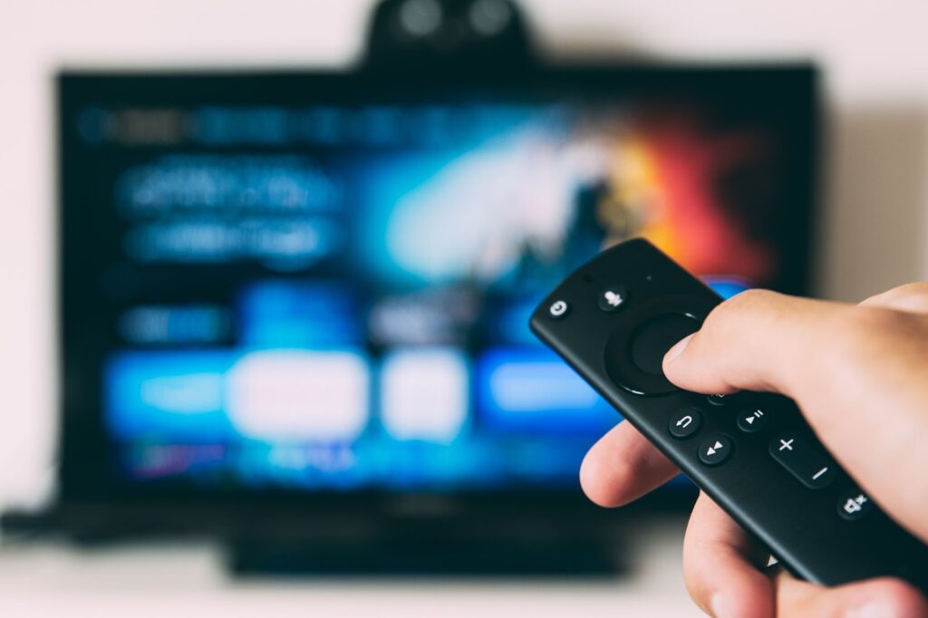 TV remote pointed at a blurred out TV