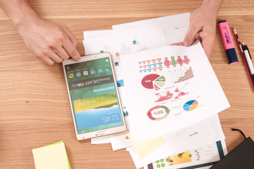 tablet and printed reports on a table
