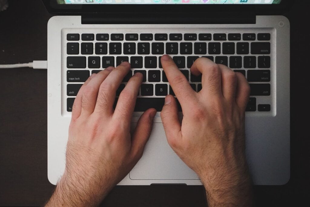 overhead shot of typing on laptop